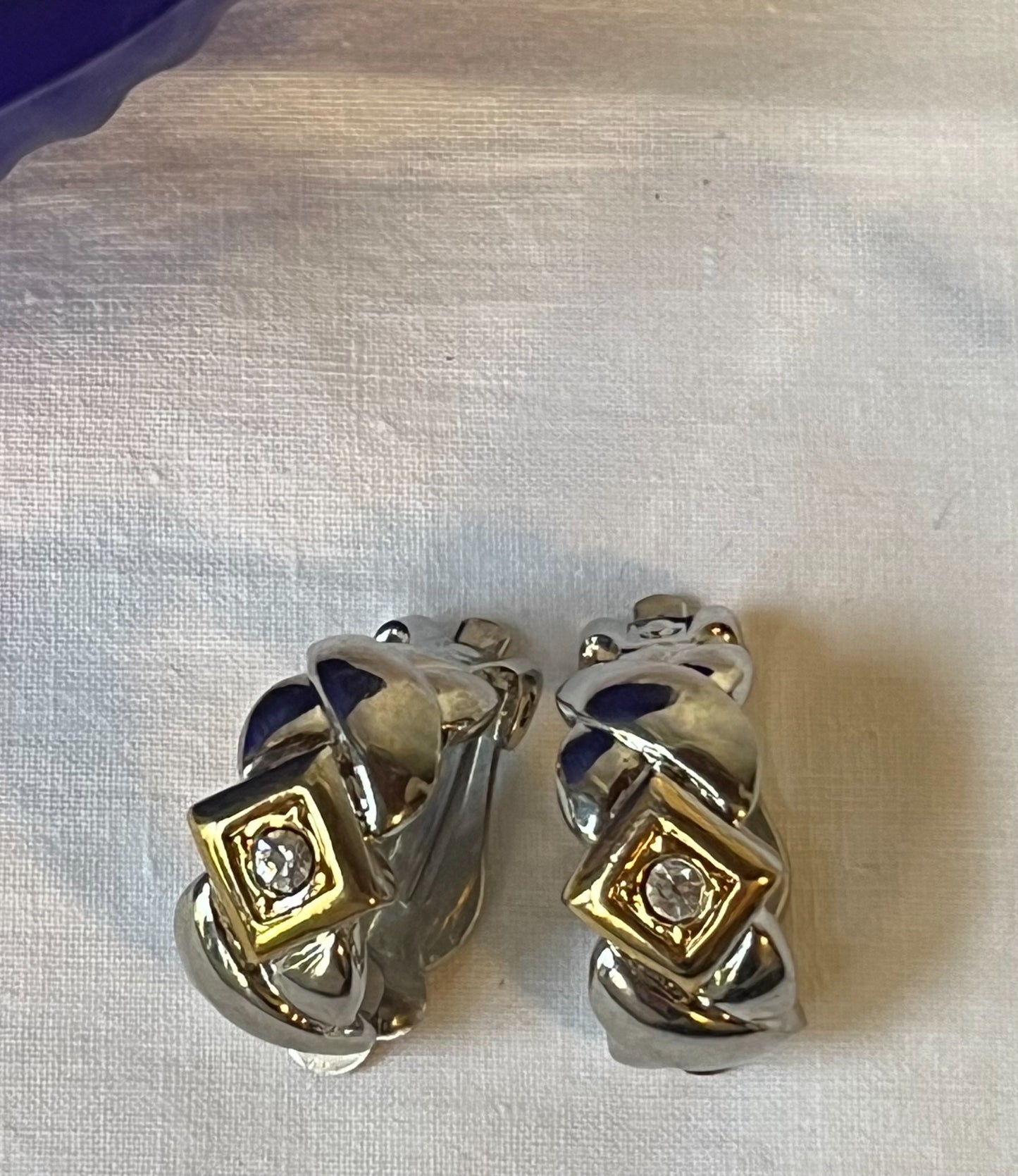 Close-up vintage two-tone sculptural rhinestone earrings