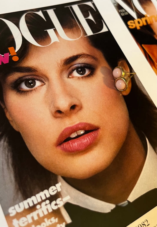 Vintage blush pink cabochon gold-tone earrings on Vogue magazine