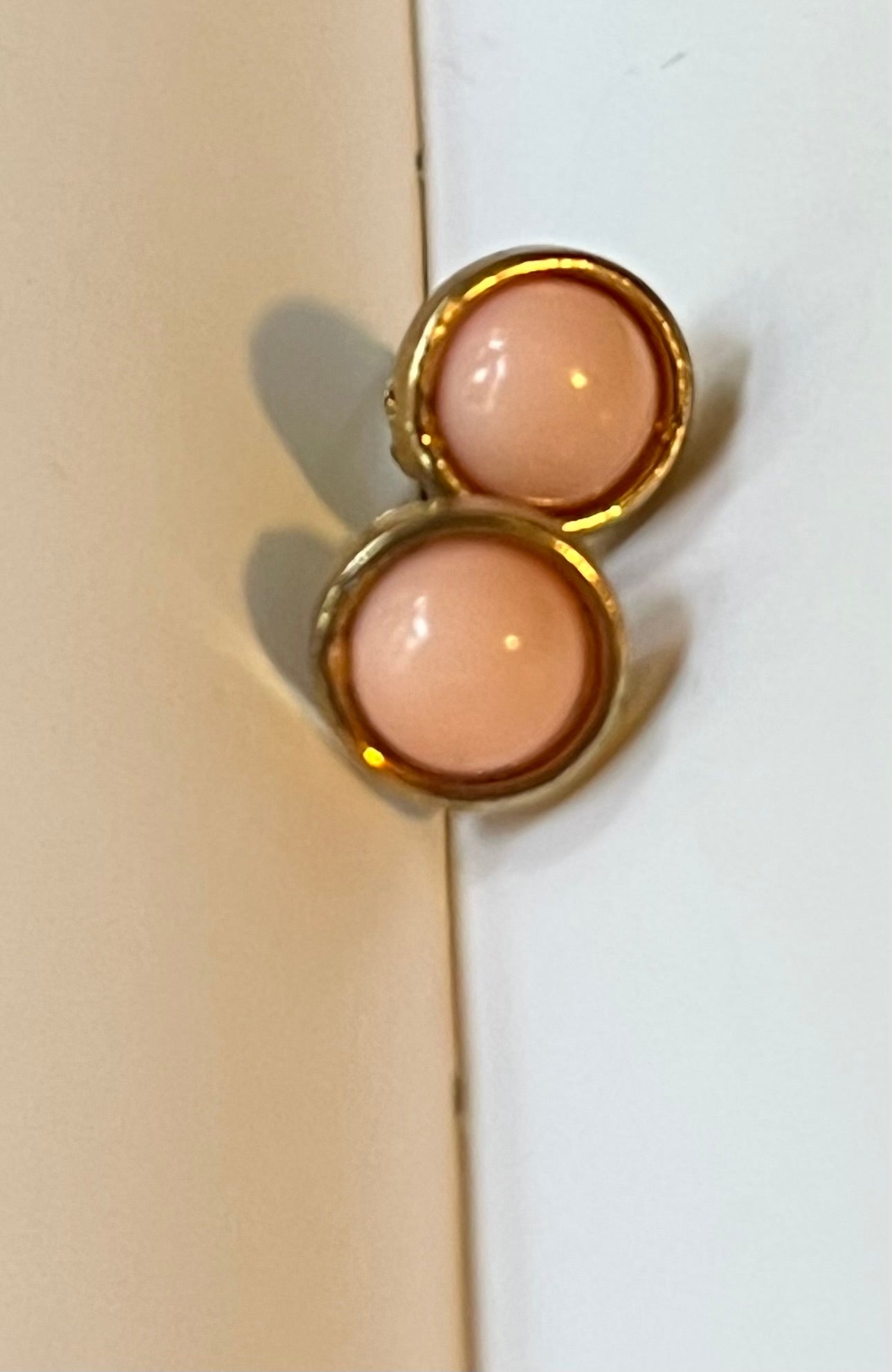 Close-up of vintage blush pink cabochon gold-tone earrings