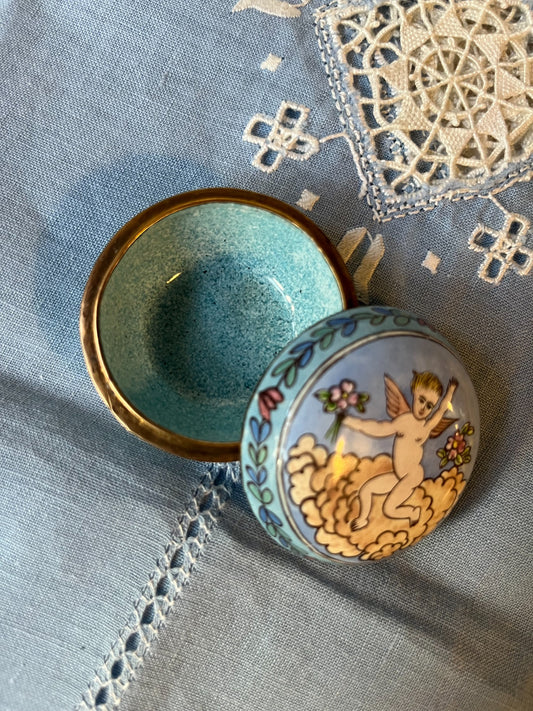 Vintage round porcelain trinket box with cherub decoration