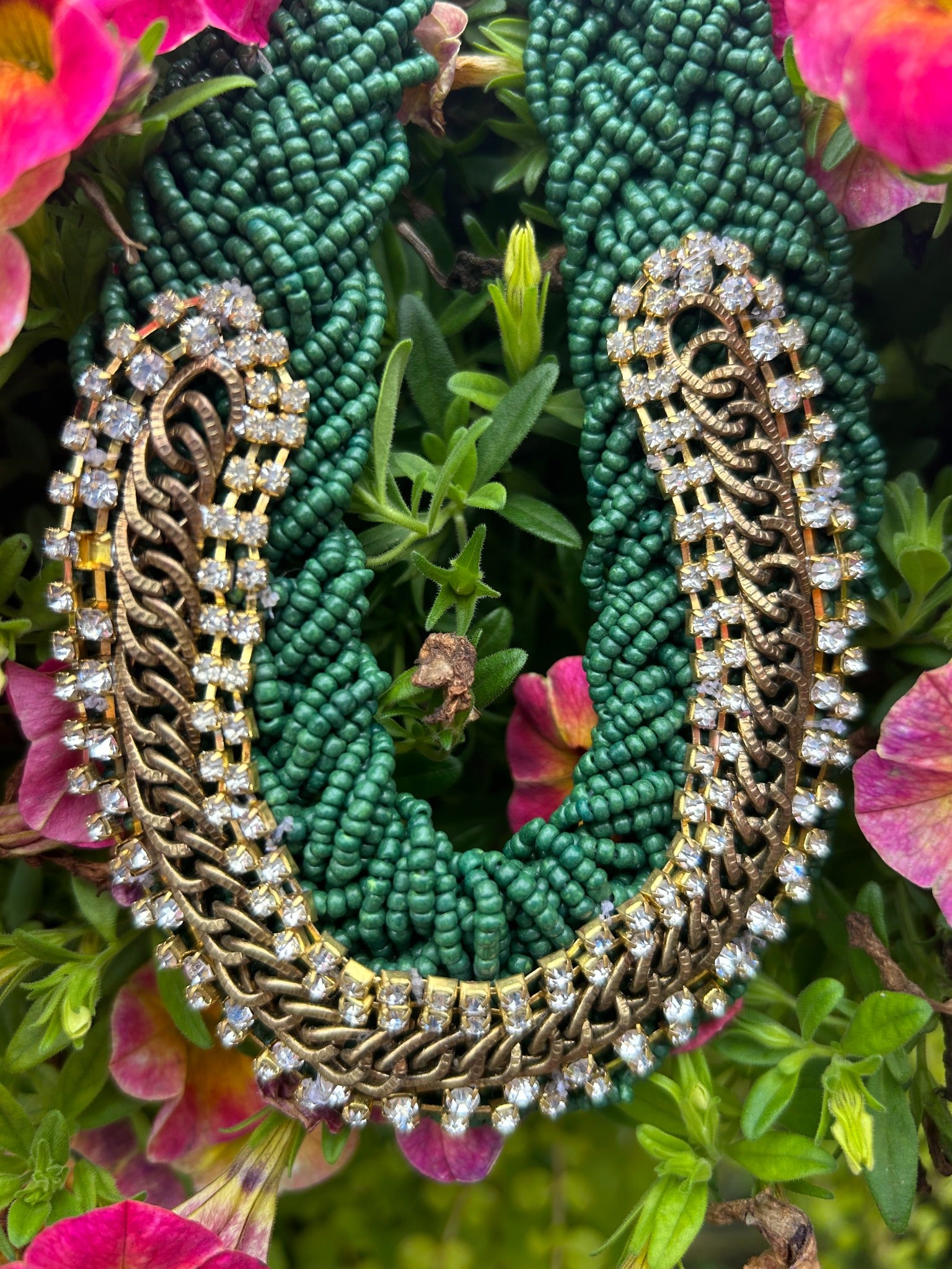 Close-up of vintage emerald green seed bead and rhinestone statement necklace