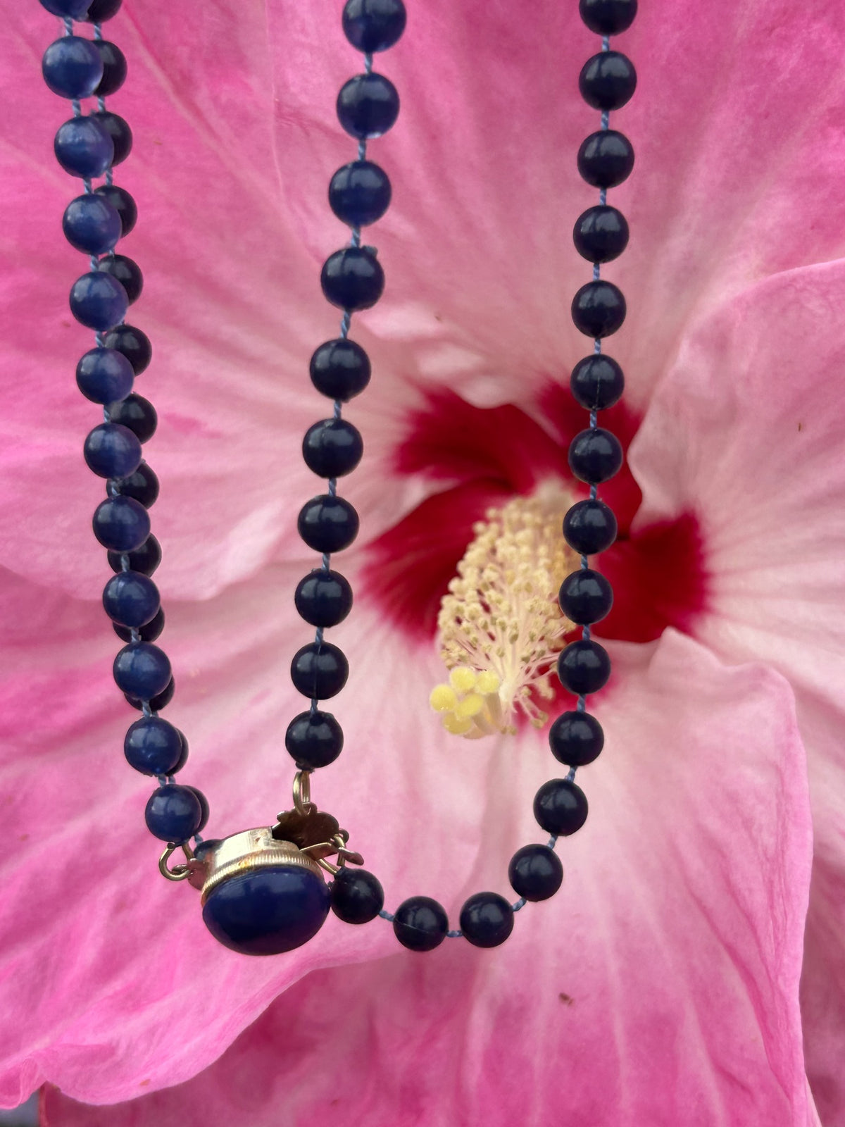 Close-up of vintage navy blue double-strand bead necklace and clasp