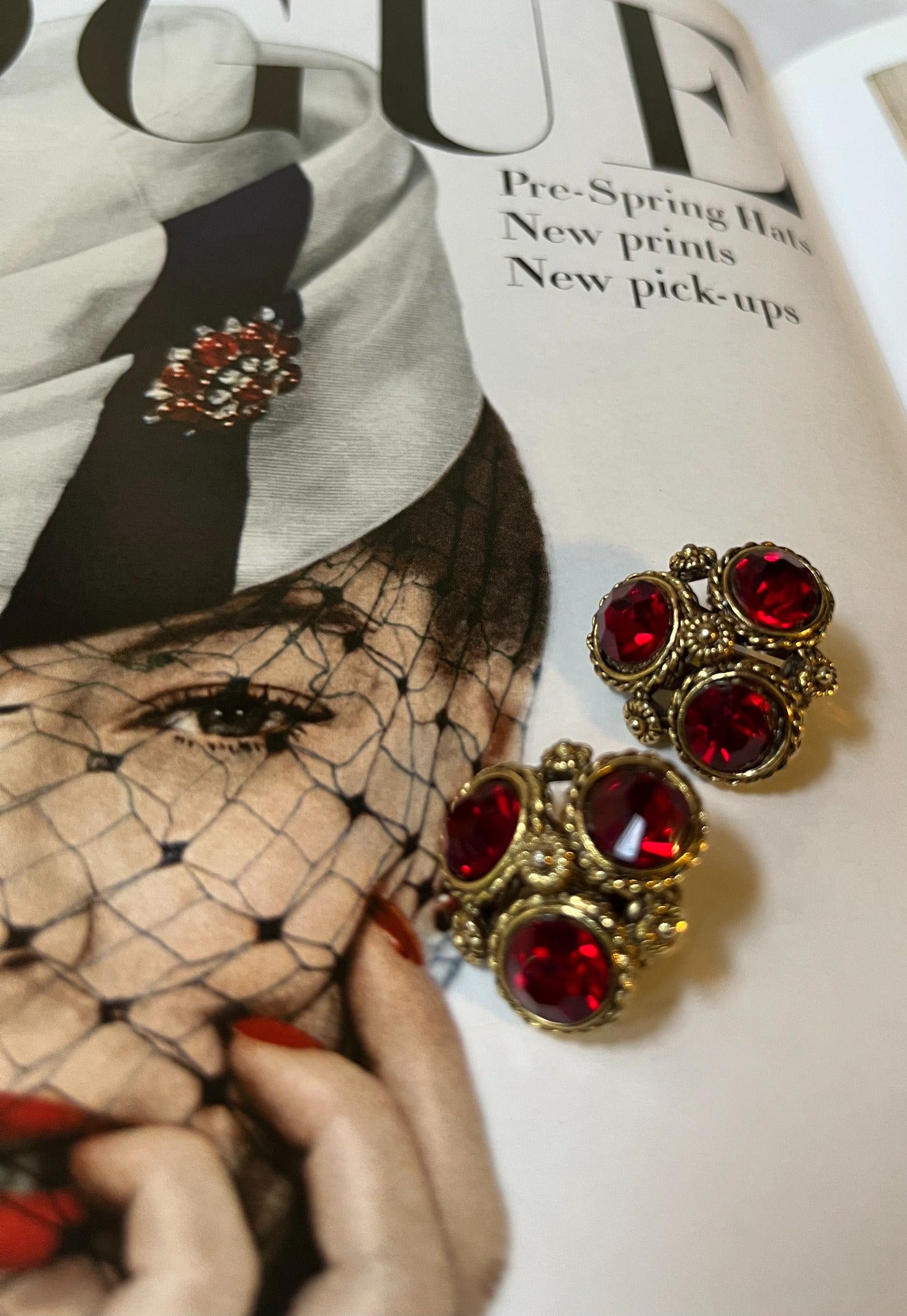 Close-up vintage ruby red rhinestone cluster earrings