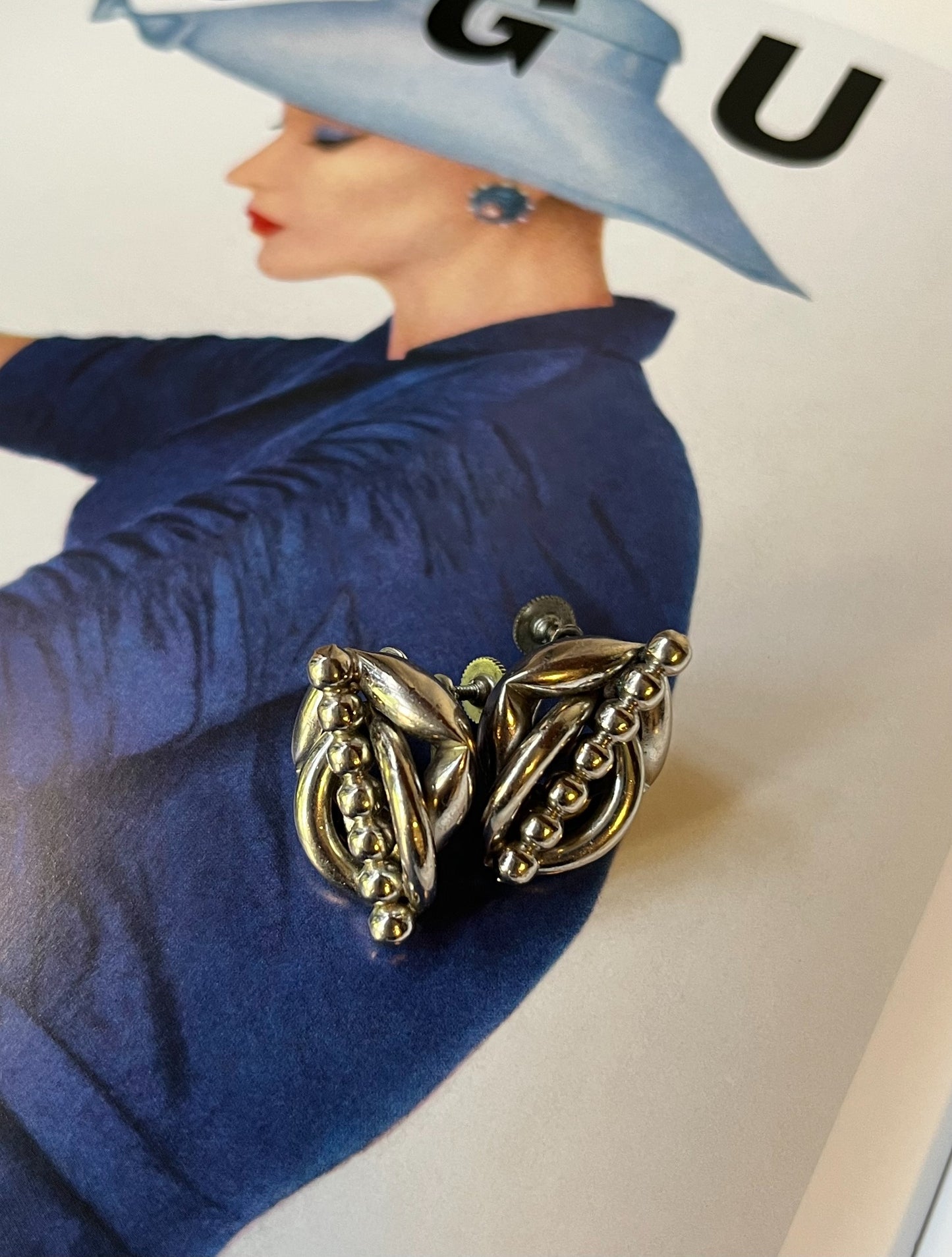 Close-up vintage silver-tone sculptural modernist screw-back earrings