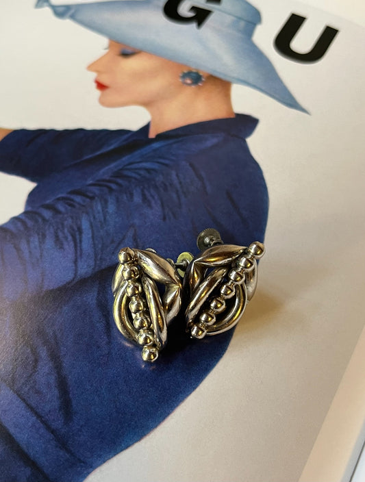 Close-up vintage silver-tone sculptural modernist screw-back earrings
