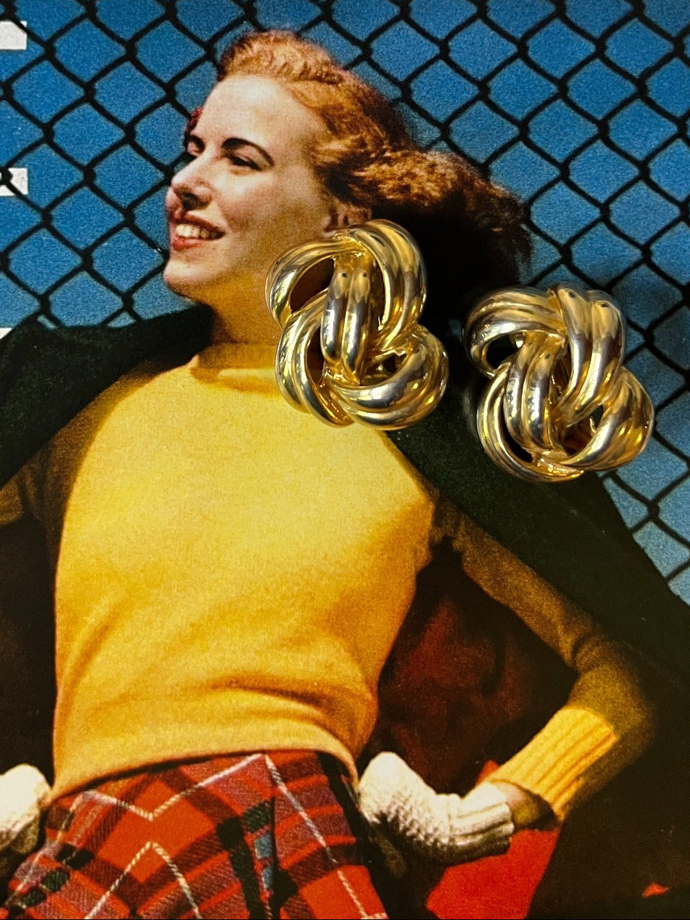 Close-up vintage chunky two-tone gold and silver knot earrings